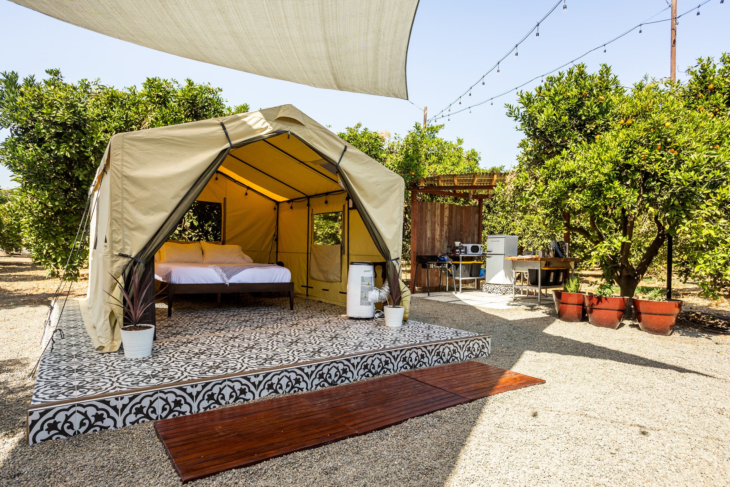 Side view of the tent beneath shade sails