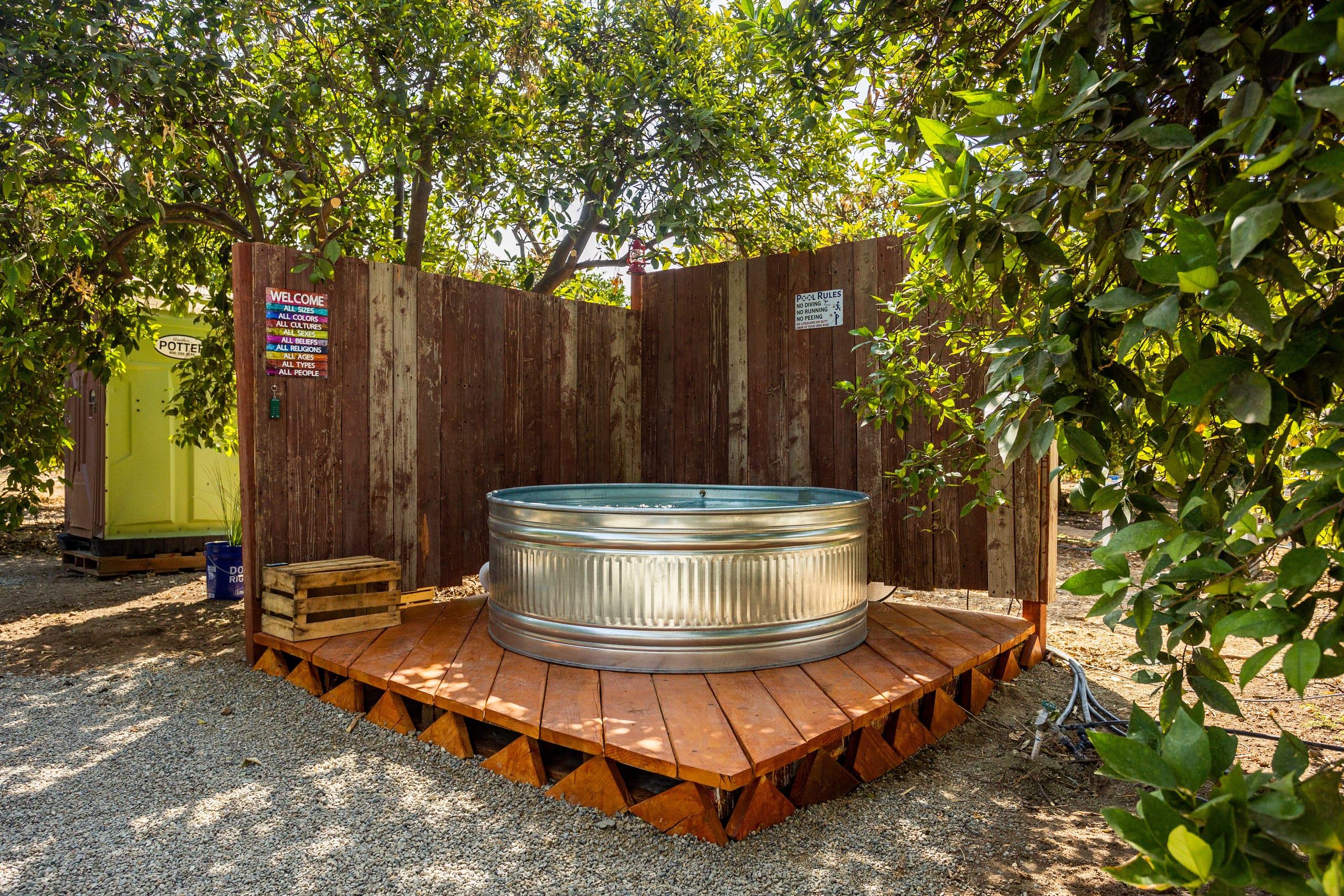 Outdoor hot tub tucked among orange trees at The Grove Retreat