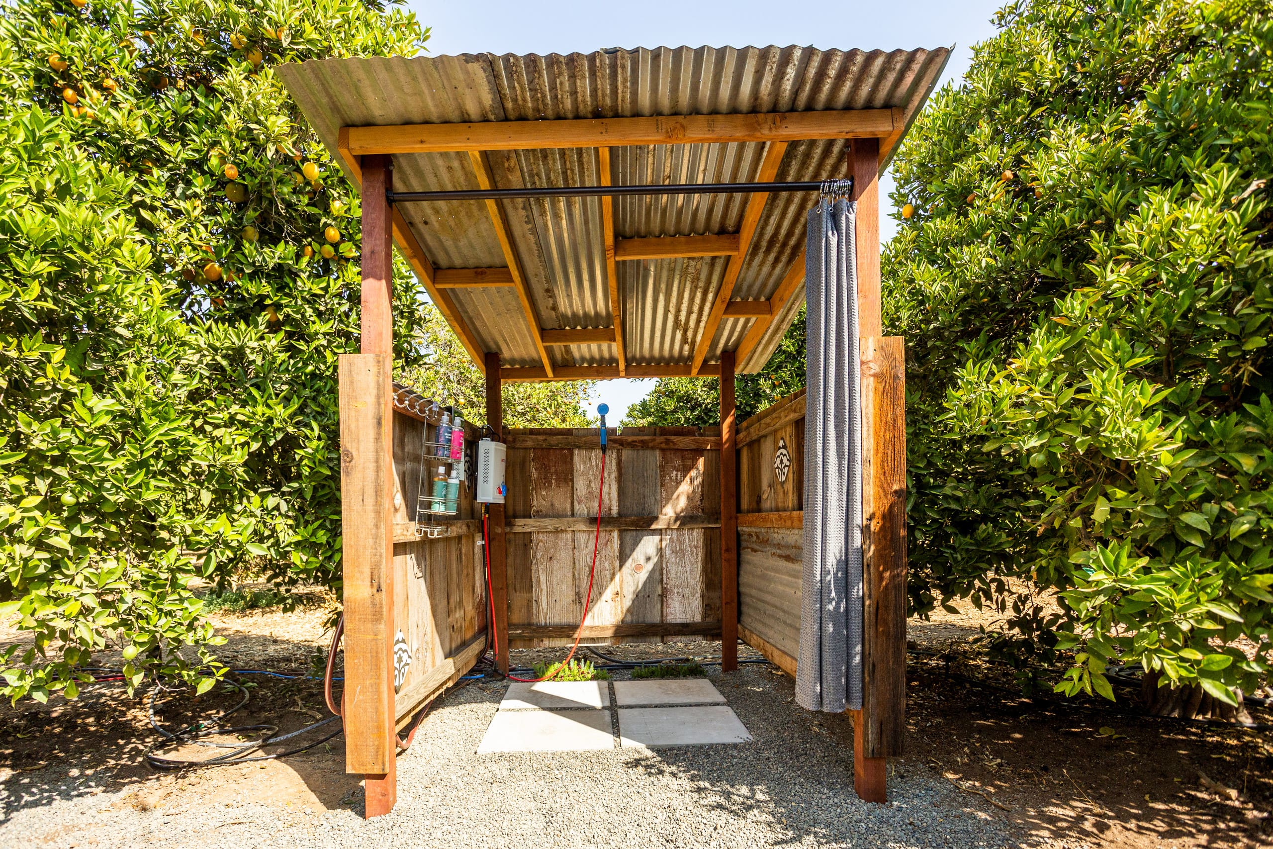 Outdoor shower and dining area at The Grove Retreat